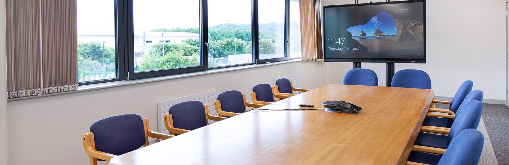 Boardroom with large presentation television and table and chairs