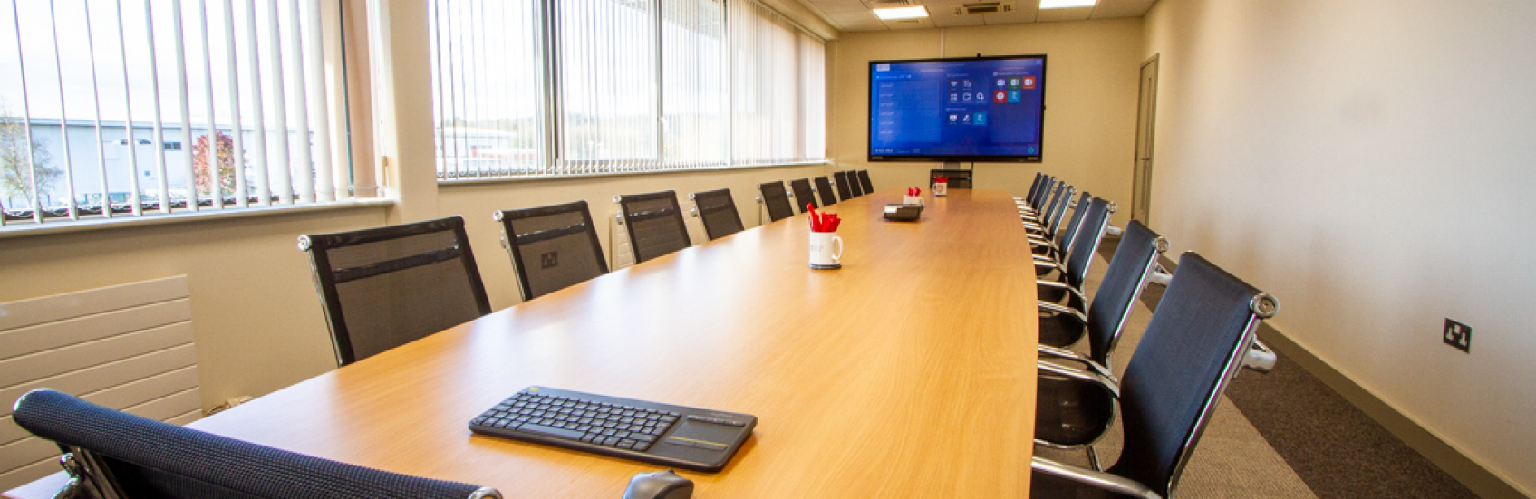 Boardroom with large presentation television and table and chairs