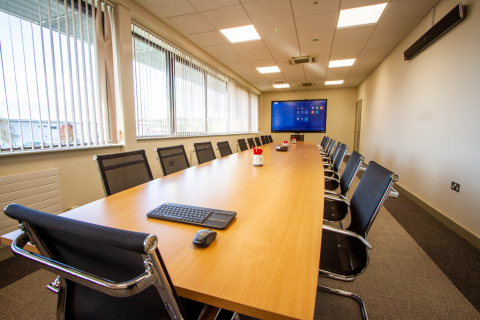 Boardroom with large presentation television and table and chairs
